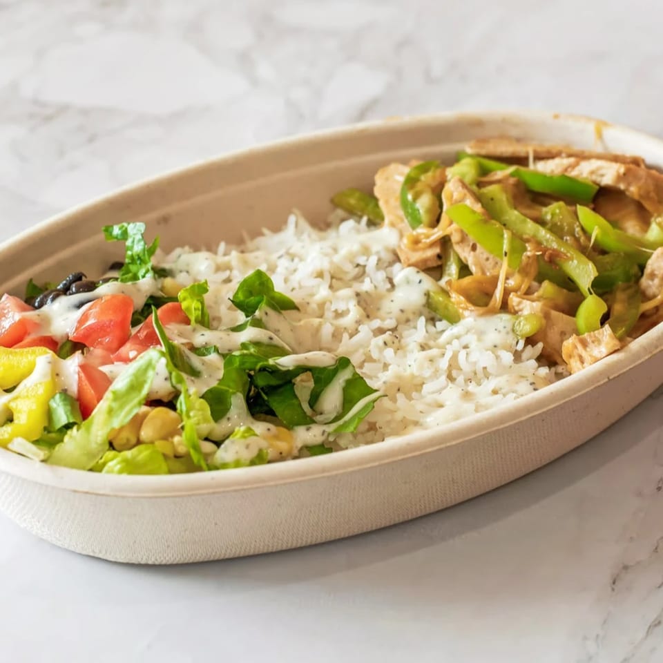 Veg-O-Rama vegan bowl with rice, salad, and a stir-fry of green peppers and tofu.